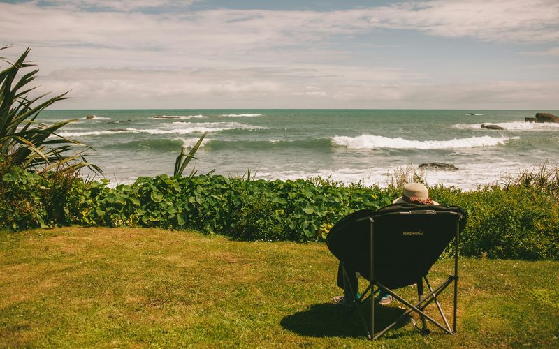 Person relaxing by ocean